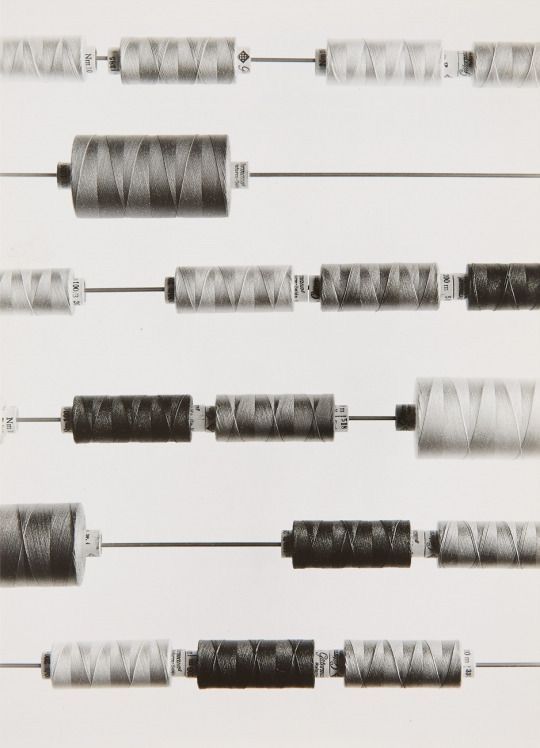 Thread spools arranged across horizontal needles